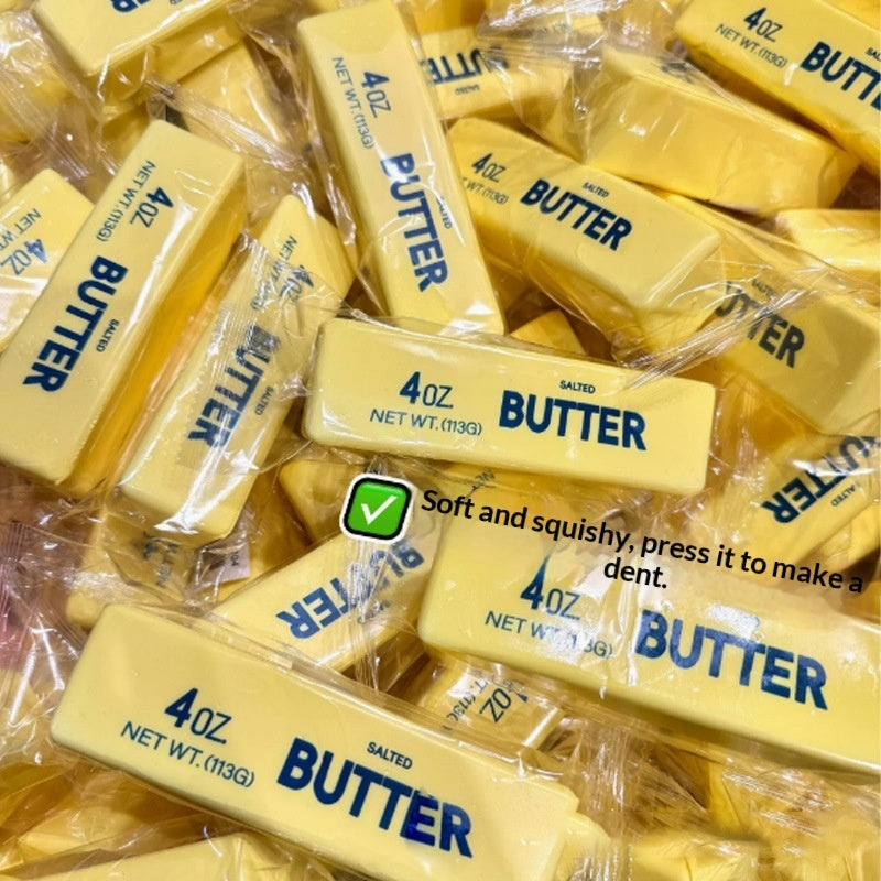 Gold “Butter” squishy stick stress toys stacked in packaging