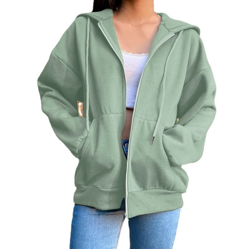 Women's hooded zip-front jacket in green with front zipper, drawstring hood, and side pockets