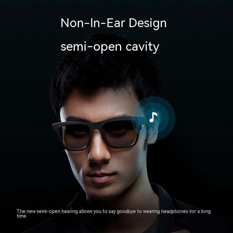 Black smart audio glasses on a person with dark lenses and thick frame