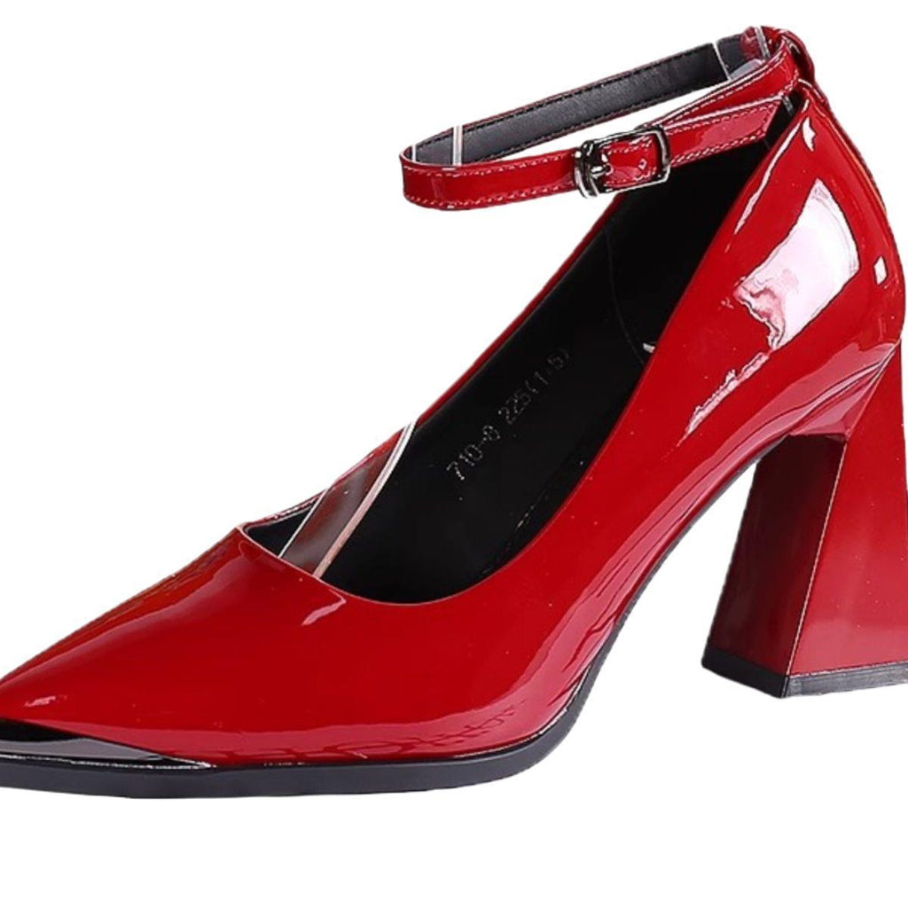 Red patent slingback pumps with pointed toe, ankle strap, and block heel close-up