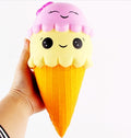 Squishy toy: yellow cone with orange waffle texture, pink cloud top, smiling face