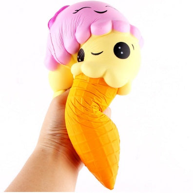 Squishy toy held in hand: yellow cone with orange waffle texture and pink cloud head