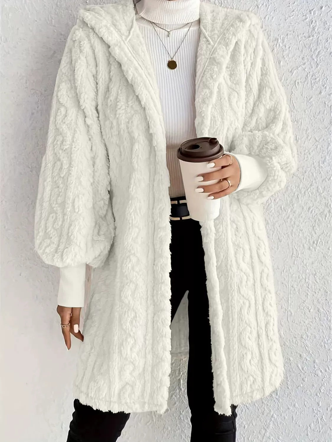 White hooded plush long coat with textured fabric, long sleeves, and front pockets