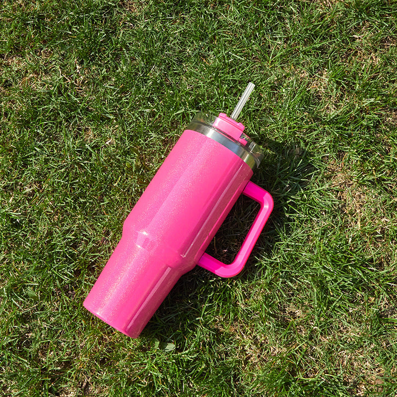 Large insulated stainless steel tumbler, bright pink finish with clear lid and straw, side handle
