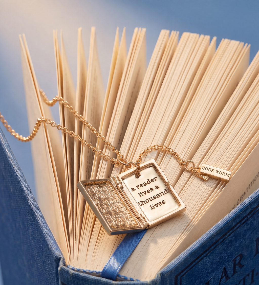 Gold book club locket pendant on chain over a bookish accessory bundle