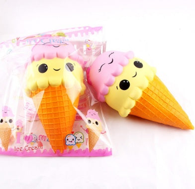 Two squishy ice-cream cone toys with pink cloud tops and smiling faces in package