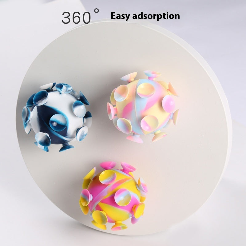 Four silicone stress balls arranged in a tray: pastel, blue, yellow-pink, and dark blue