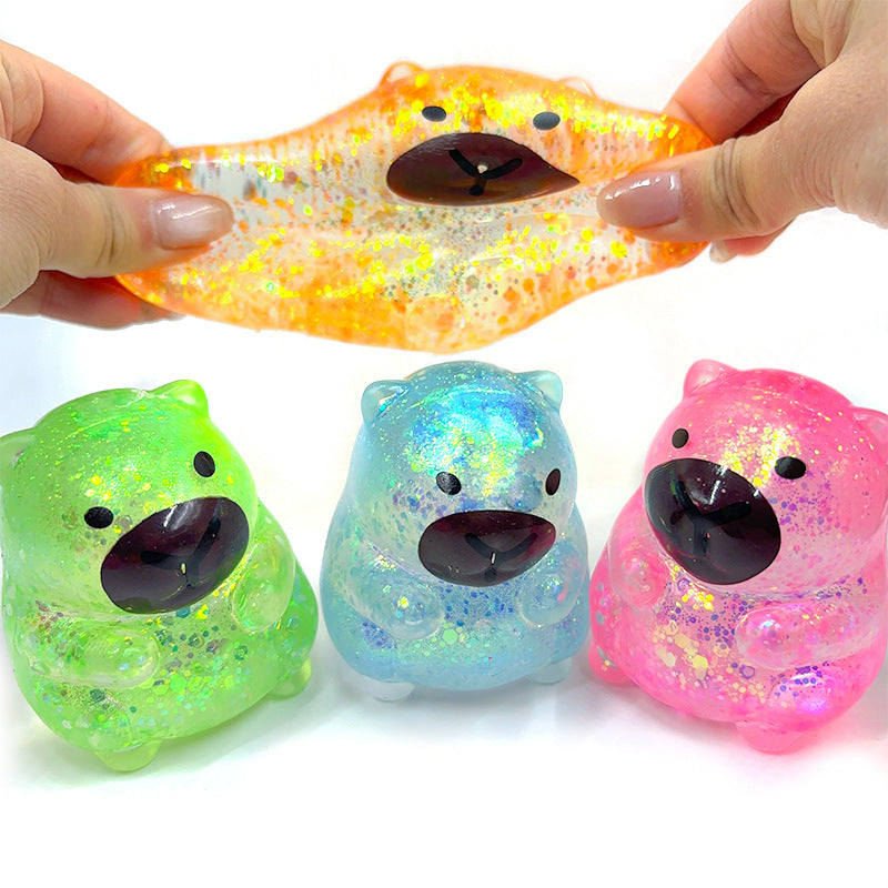 Orange capybara-shaped squishy candy stress toy, glossy face with black nose and eyes