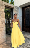 Yellow pleated halter maxi dress with bow-tie front and wide flowing skirt