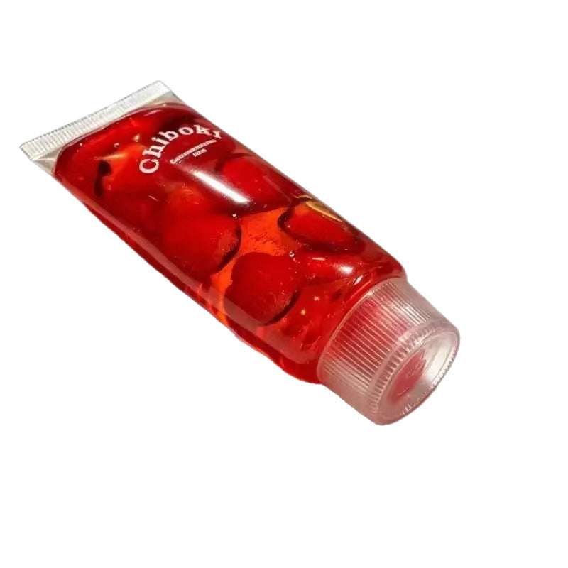 Red squishy toothpaste squeeze toy tube with glossy gel look and silver cap