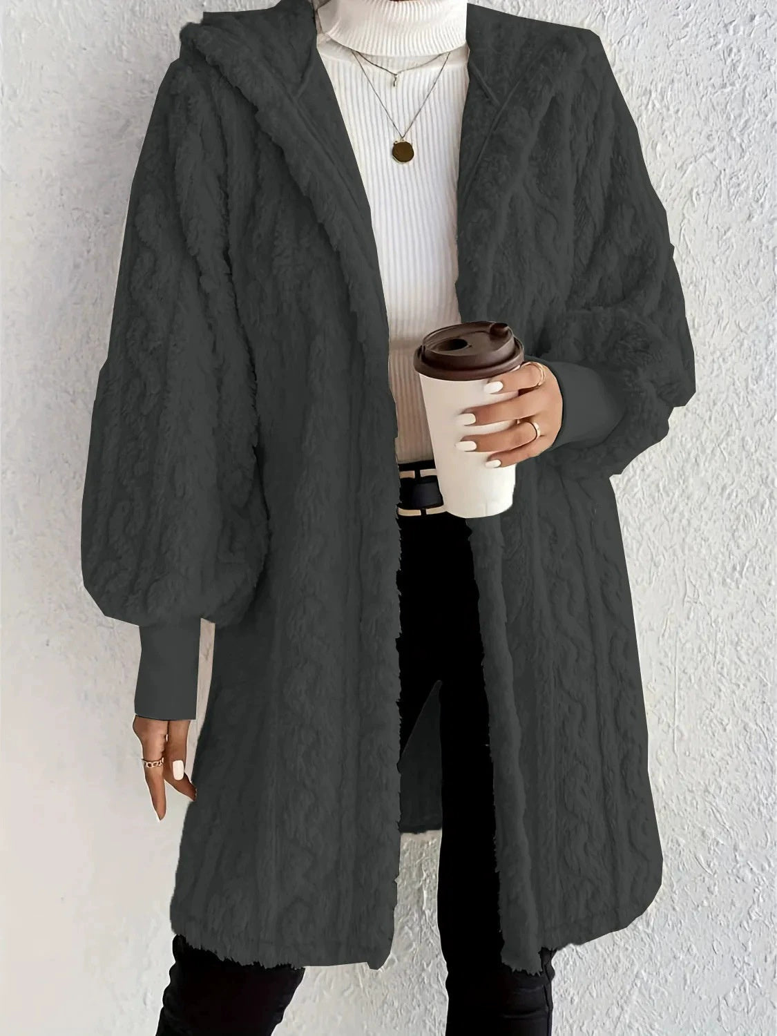 Hooded long plush coat in black, open front, hooded neckline, fluffy texture.