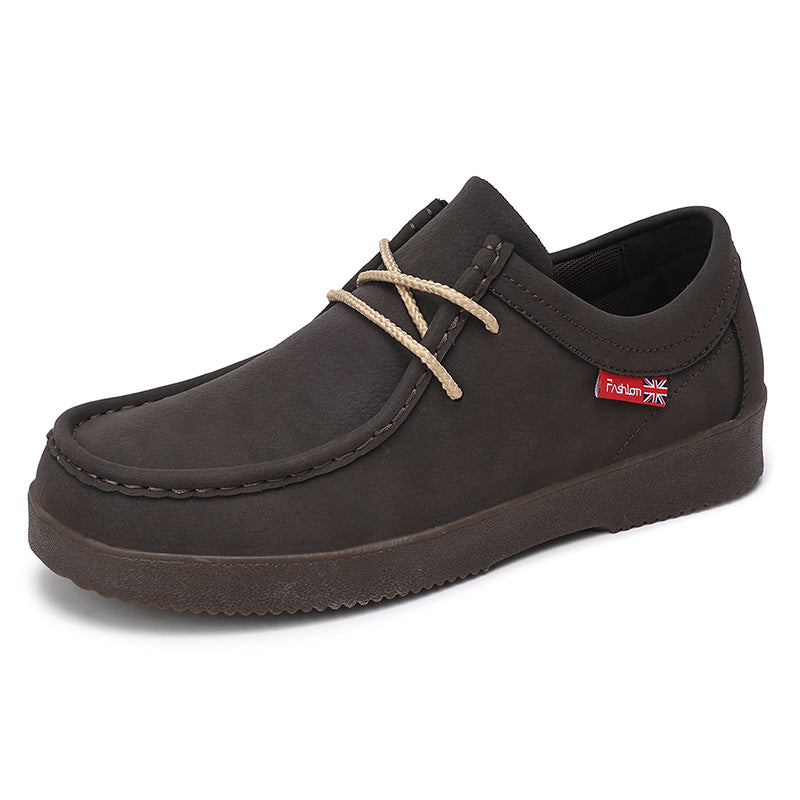 Black suede low-top lace-up loafer with tan laces, dark rubber sole, stitched toe seam.