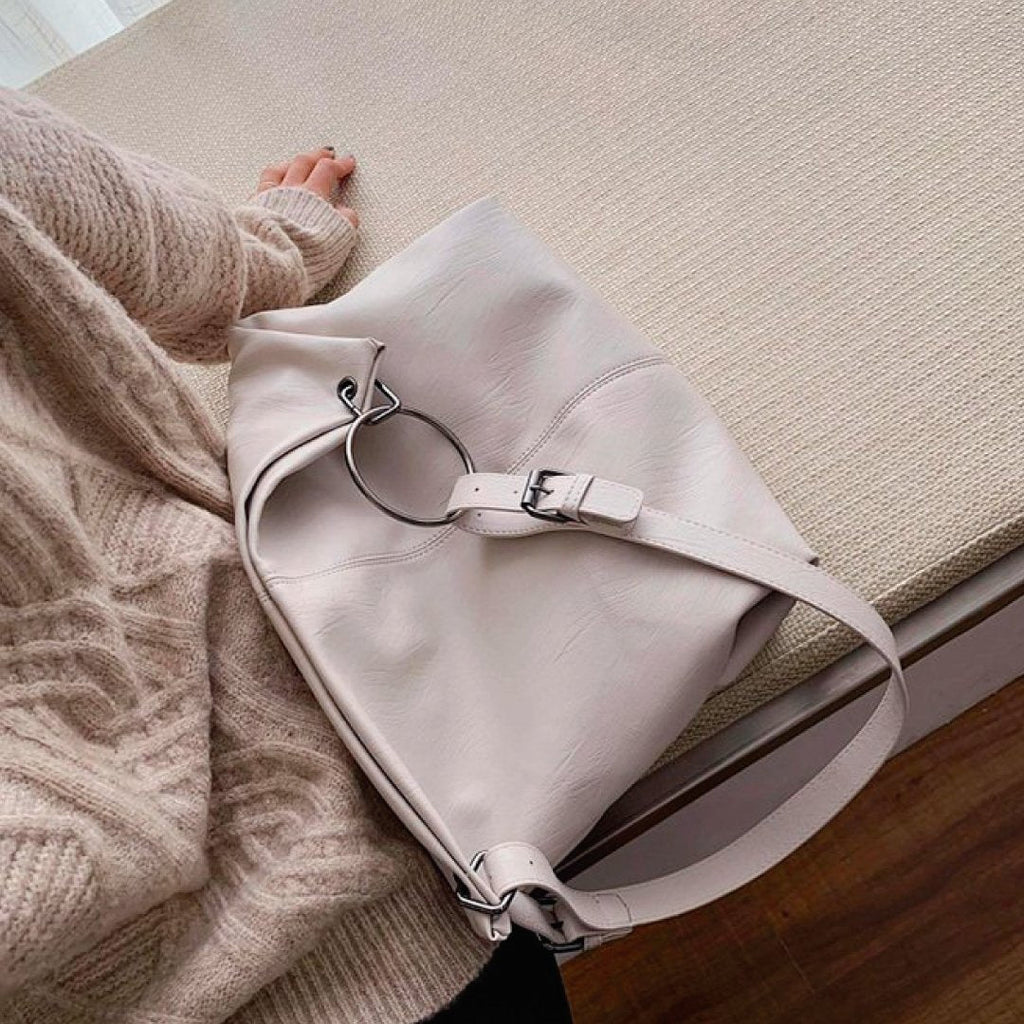 Light ivory shoulder bag with adjustable strap and metal ring hardware