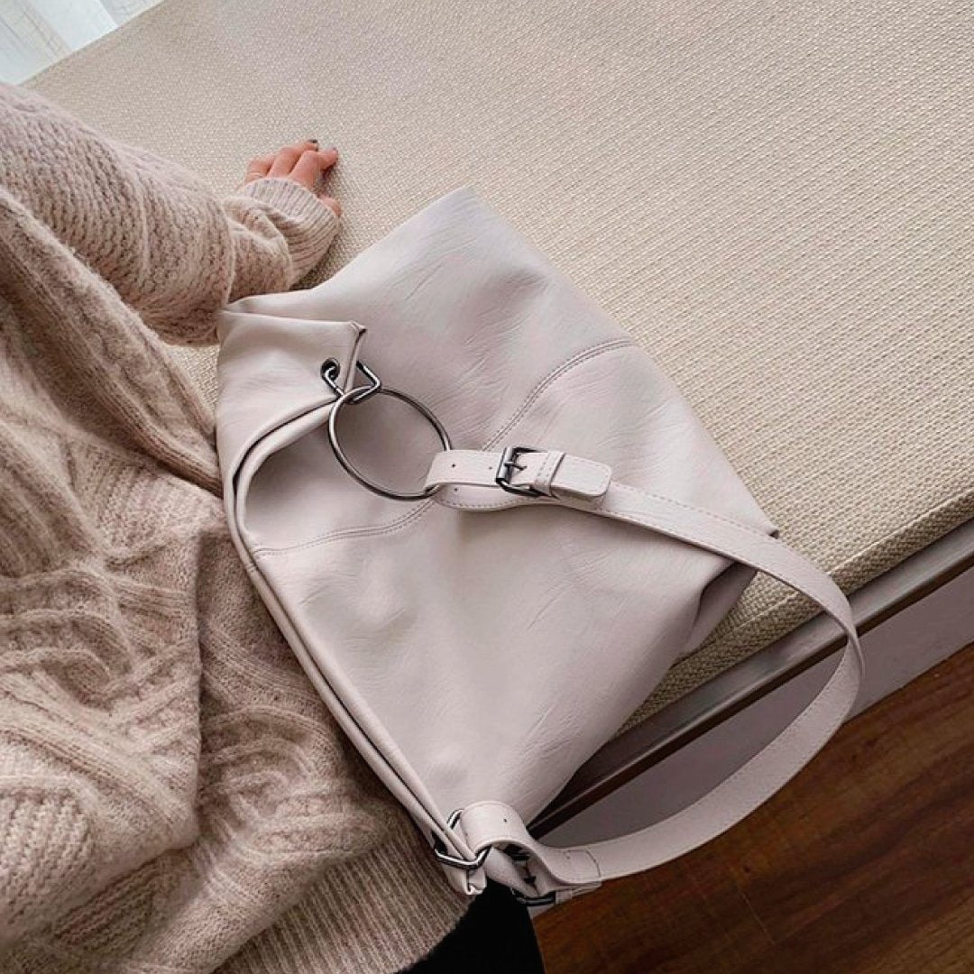 Light ivory shoulder bag with adjustable strap and metal ring hardware