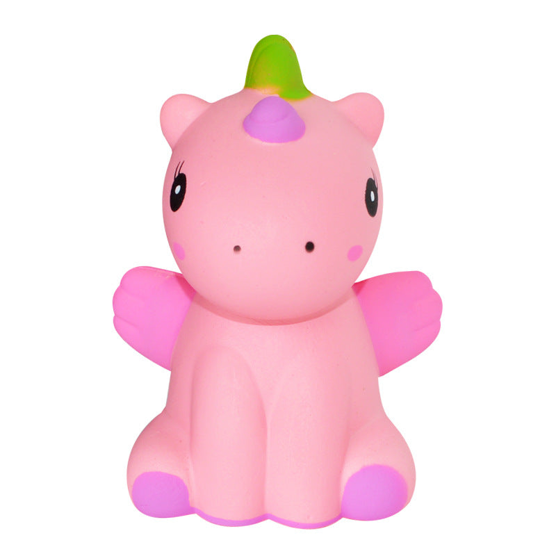 Pink unicorn squishy toy with green horn, purple nose, and winged arms