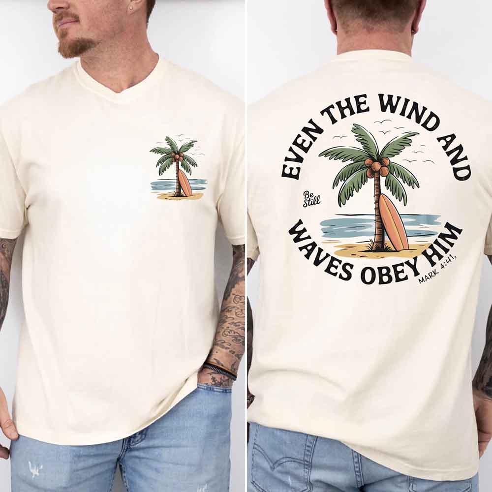 White unisex graphic tee with palm tree artwork and small "Be Still" emblem on chest
