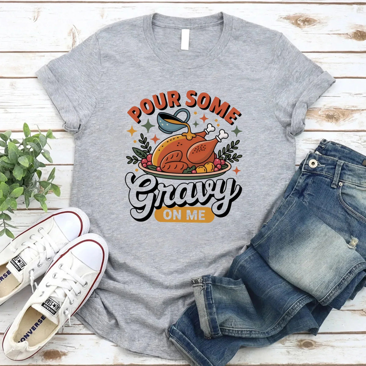 Grey T-shirt with turkey gravy graphic reading “Pour some Gravy on me”.
