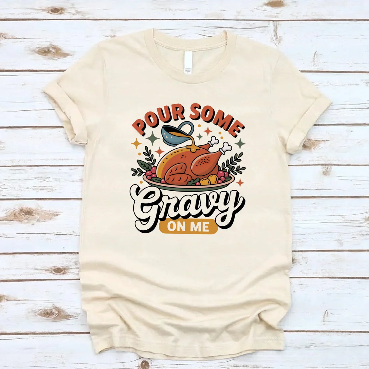 Cream T-shirt with turkey gravy graphic reading “Pour some Gravy on me”.