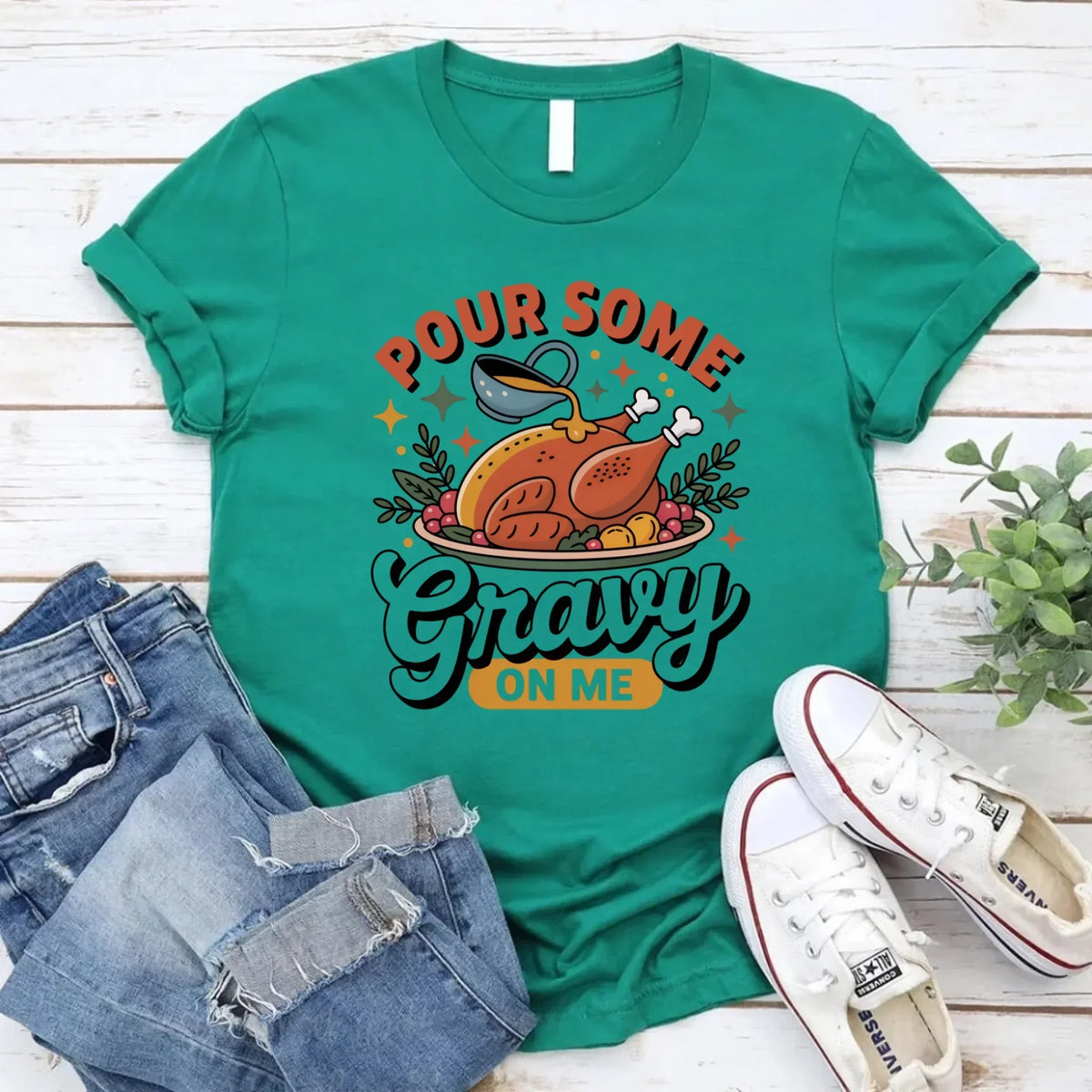 Green T-shirt with turkey gravy graphic reading “Pour some Gravy on me”.