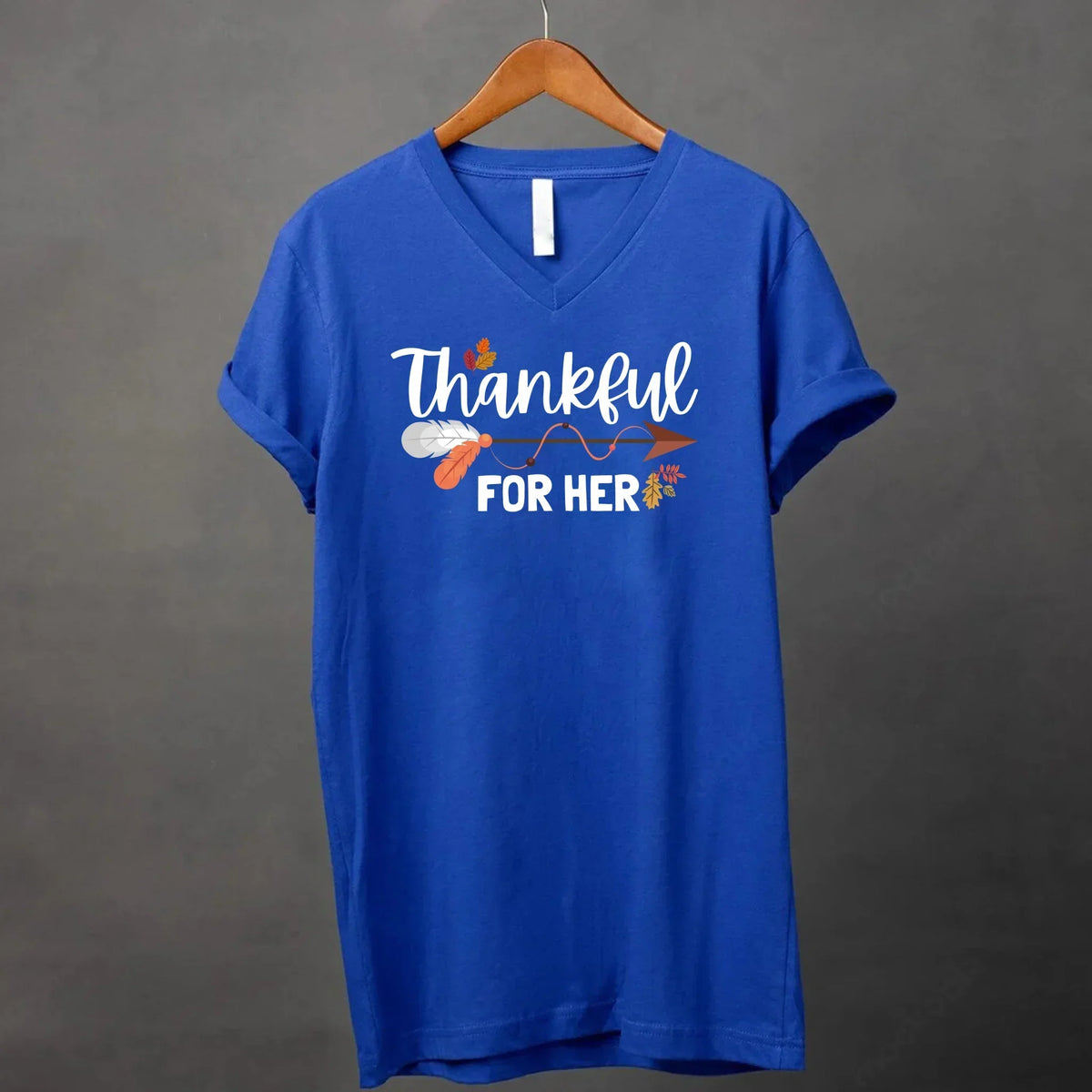 Royal blue v-neck T-shirt with white script 'Thankful for her' and autumn leaf print