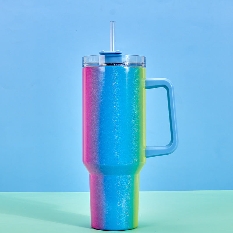 Large insulated stainless steel tumbler with iridescent rainbow finish, clear lid, straw, handle