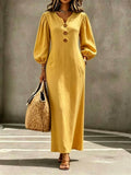 Wheat gold V-neck maxi dress with puff sleeves and button front, A-line silhouette.