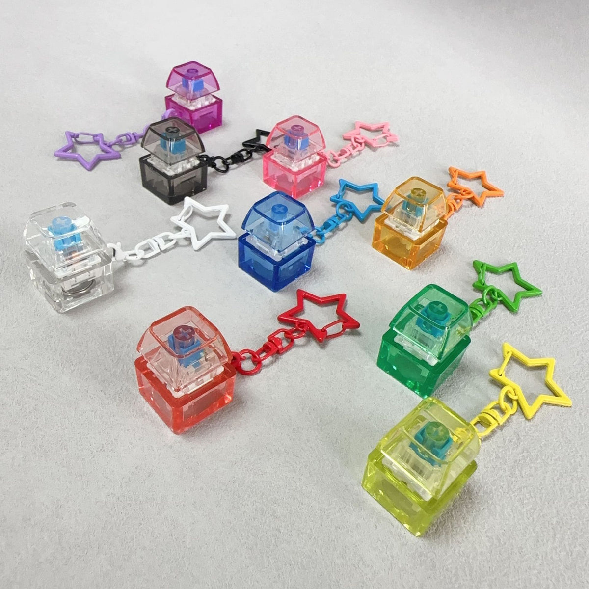 Mechanical keyboard stress-relief keychain set with multiple colored cube charms and stars