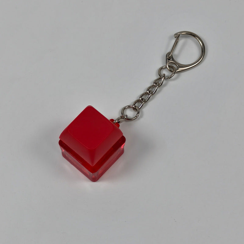 Red square finger-popping stress-relief keychain toy with metal chain and rings