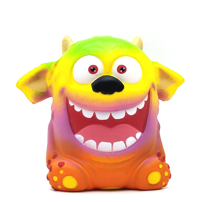 Colorful monster plush toy with open mouth, big red eyes, and orange body