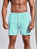 Men's teal-and-white striped sports shorts with elastic waist and drawstring