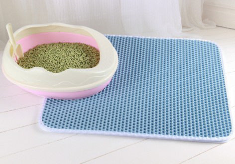 Honeycomb cat litter mat, blue textured grid on floor next to litter box