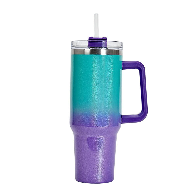 Insulated stainless steel tumbler with teal-to-purple gradient finish, handle, and clear lid