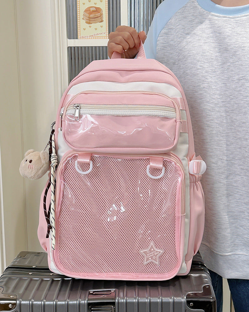 Pink nylon backpack with front zip pocket, mesh panel, and star patch