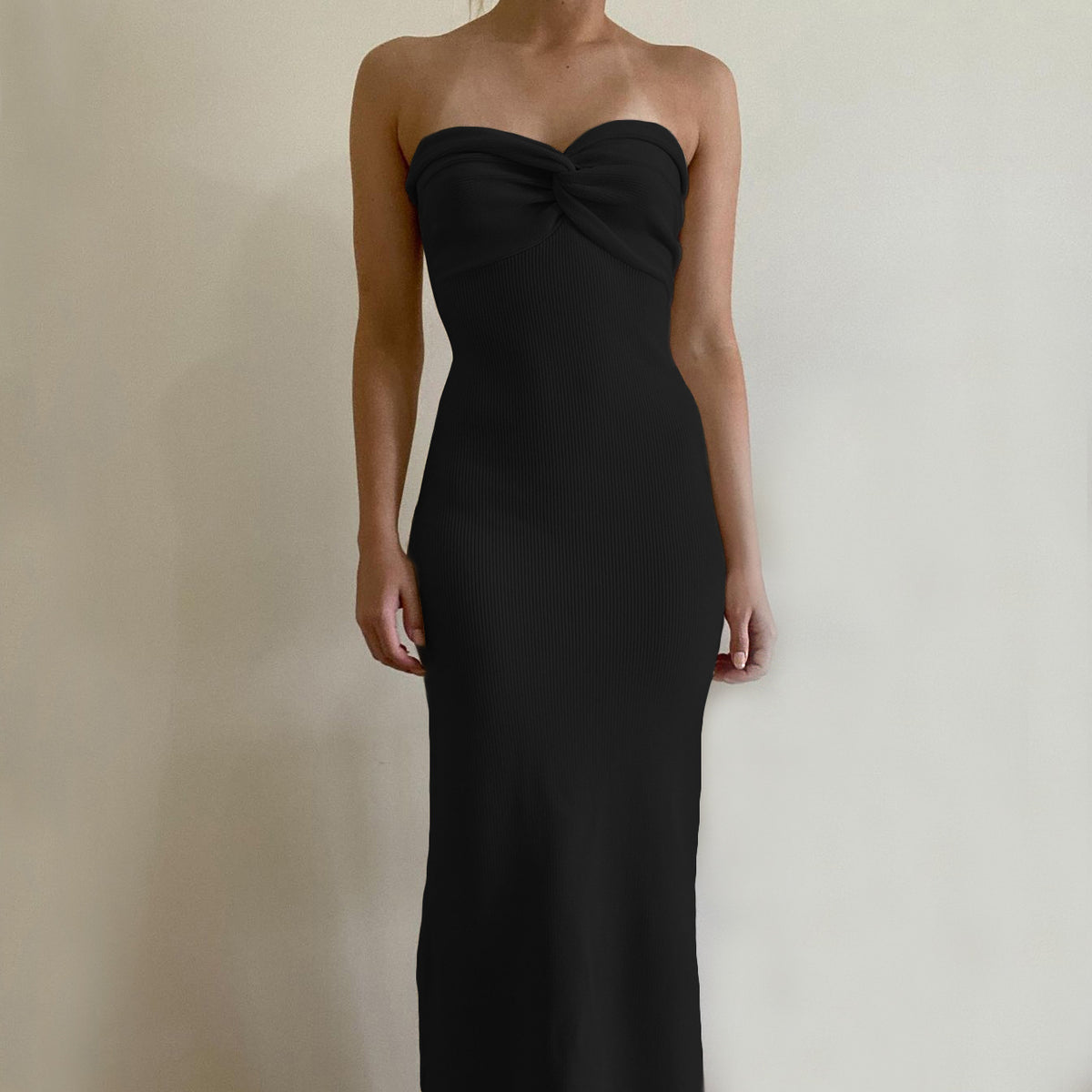 Black off-shoulder knit long dress with knotted bust and smooth fitted column.