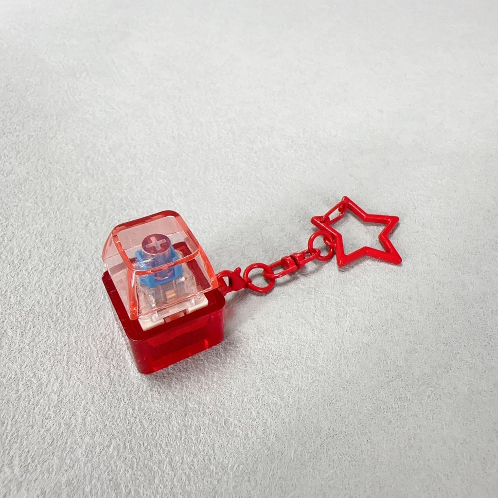 Red cube mechanical keyboard stress-relief keychain with star charm and chain