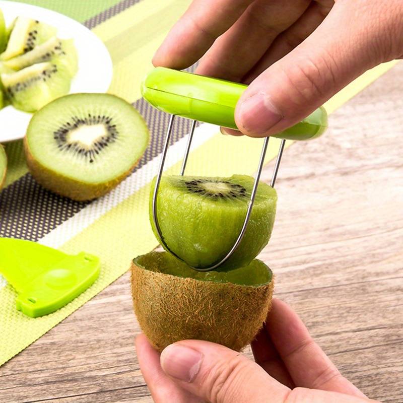 Green kiwi peeler and splitter tool piercing a kiwi half