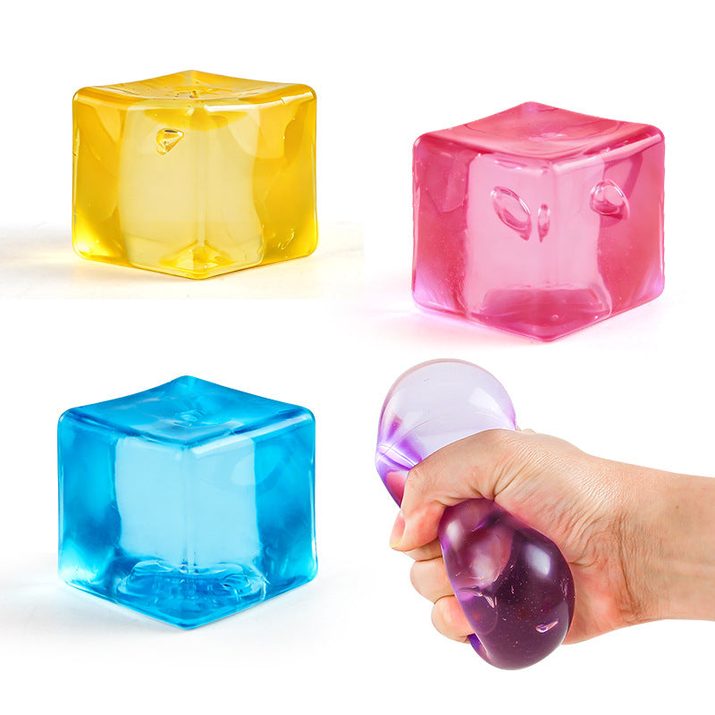 Children's square fidget balls in yellow, pink, and blue, held in a hand