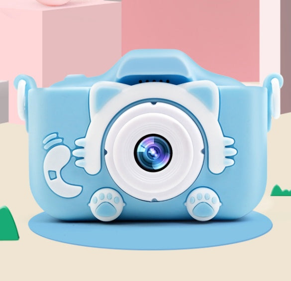Light blue digital camera toy with large circular lens and dinosaur paw-shaped base feet