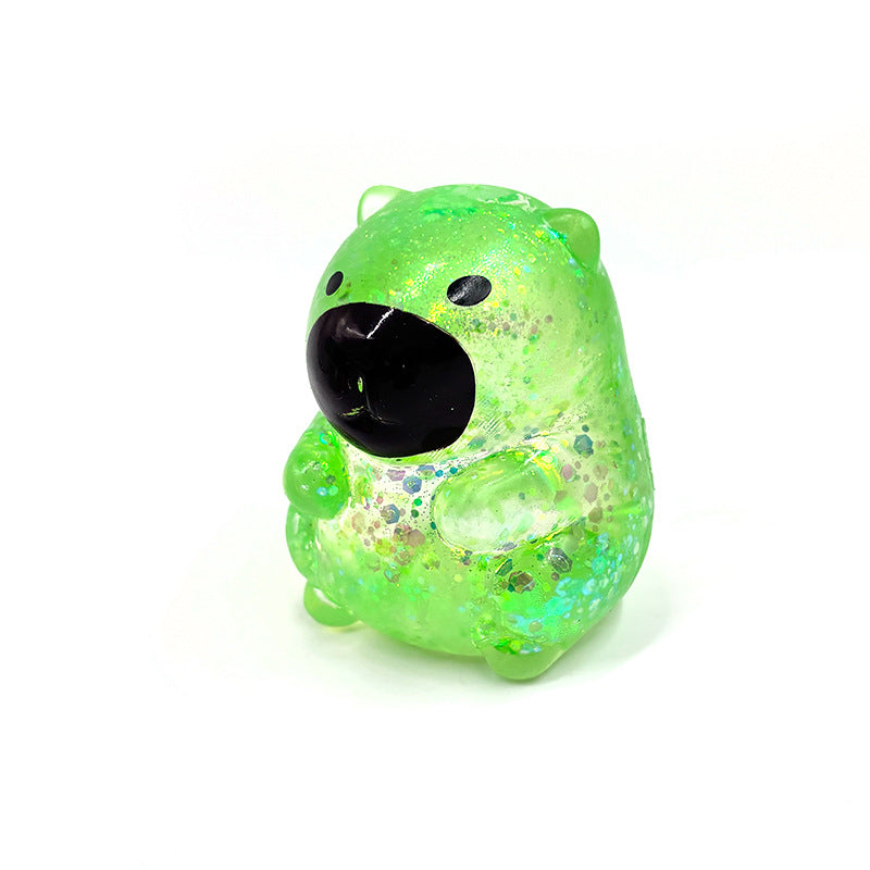 Green capybara-shaped squishy candy stress toy, glittery translucent body with black face