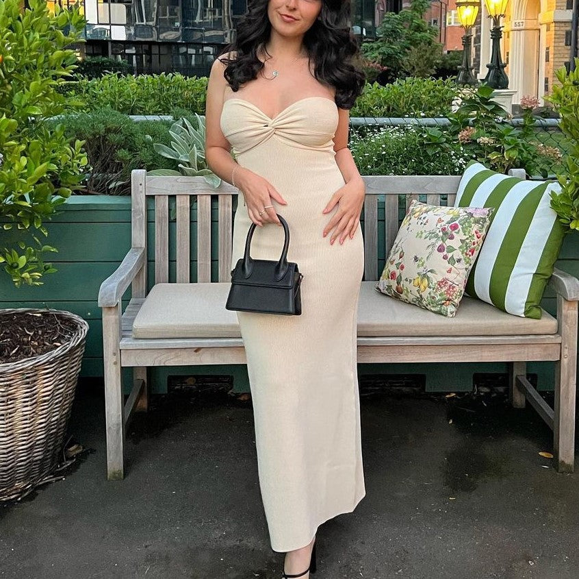 Cream off-shoulder knit maxi dress with knotted bodice, fitted through the hips.