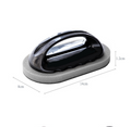 Black cleaning tool with curved handle on rectangular gray foam pad