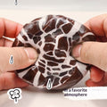 Chocolate-style crunchy ball stress toy with dark brown and white marbled cracks