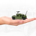 Green alloy military model toy held in hand, showing turret and antenna