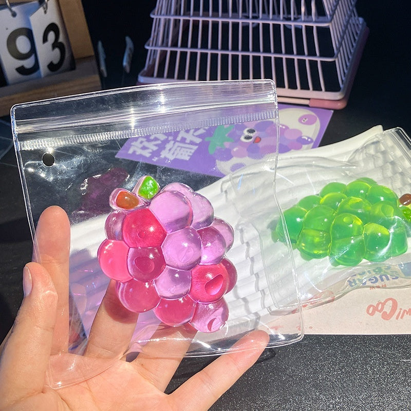 Grape-shaped stress-relief toy in clear bag, purple and green transparent clusters