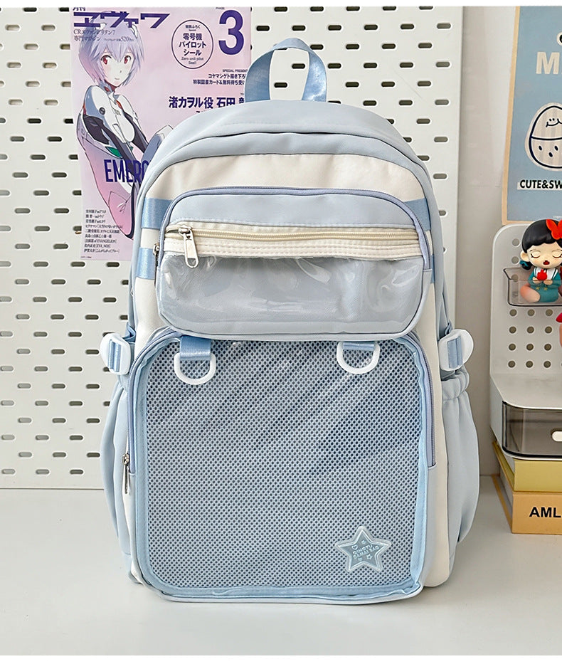 Sky blue large capacity nylon backpack with front zip pocket, mesh panel, and star badge