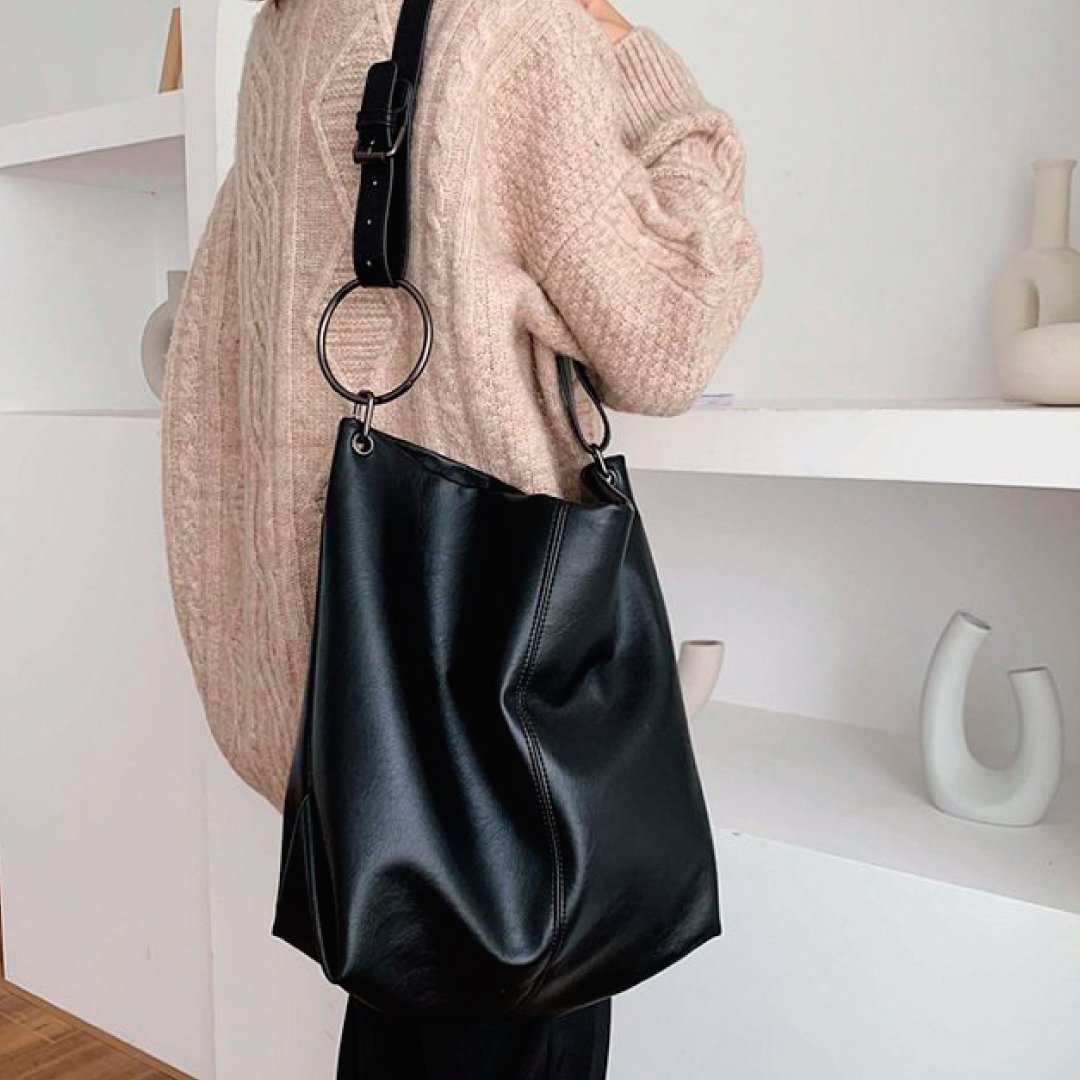 Black shoulder bag with circular ring strap hardware and smooth leather finish