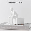 White resin seated figure bookend with rectangular block base