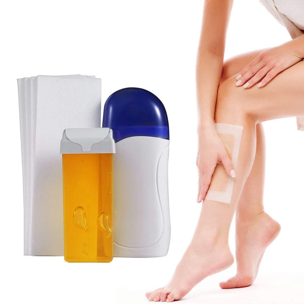 Blue and white wax machine with wax pot and strips beside leg hair removal