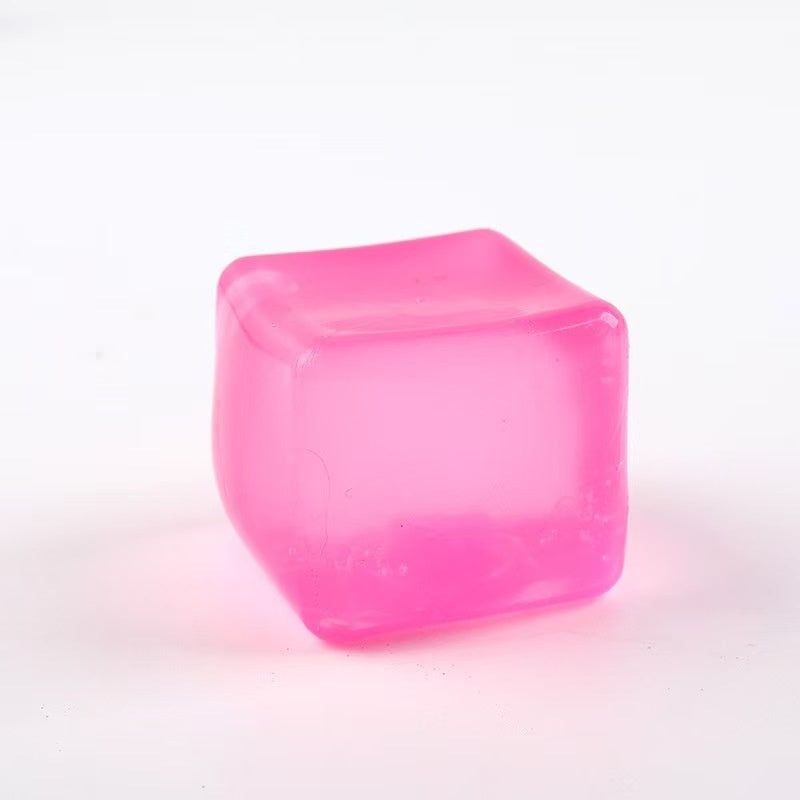 Pink translucent cube squeeze stress-relief toy with smooth rounded corners.