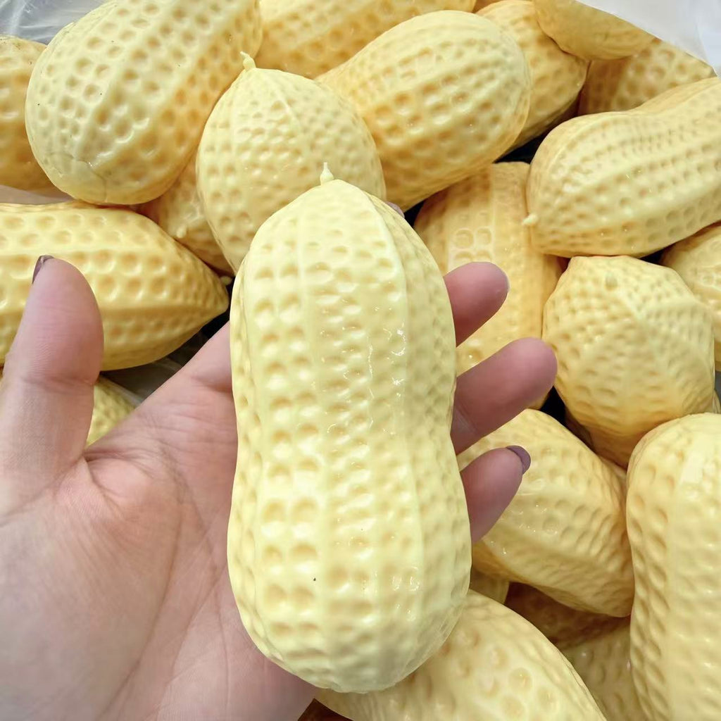 Yellow peanut squeeze stress toy with bumpy texture held up